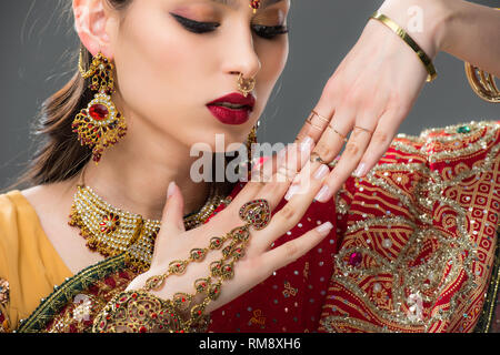 beautiful indian woman in sari and accessories on hands, isolated on grey Stock Photo