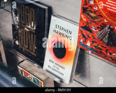 Paris, France - Dec 16, 2018: Street view of boockstore stand with cover of Brief Answers to the Big Questions by Stephen Hawking Stock Photo