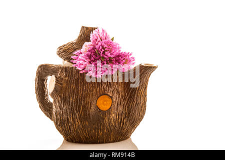 Teapot and bouquet of red clovers  isolated on white background Stock Photo