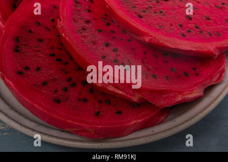 Slices of red dragon fruit on a plate close up Stock Photo