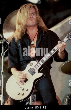 Guitarist Billy Duffy of The Cult is shown performing on stage during a concert appearance. Stock Photo