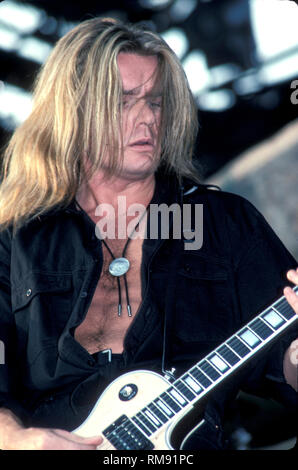 Guitarist Billy Duffy of The Cult is shown performing on stage during a concert appearance. Stock Photo