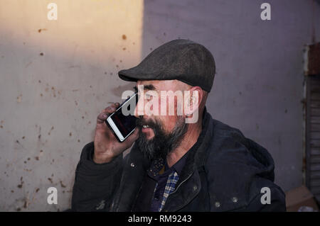 Using mobile phone Asian lod man. Stock Photo