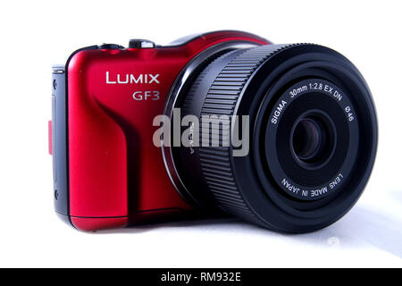 ANTIPOLO CITY, PHILIPPINES - FEBRUARY 3, 2019: A red digital mirrorless camera shot on white background. Stock Photo