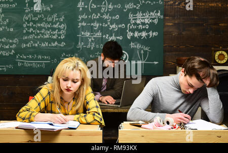 Students works honestly. Students are communicating on regular basis with the tutor. Teacher puts marks sends feedbacks on email with laptop computer. Stock Photo
