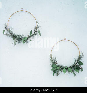 Spring or summer decor on the wall, DIY wreath of green branches Stock Photo