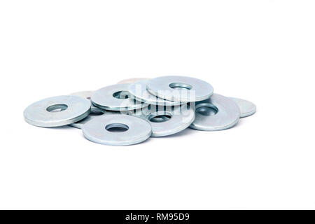 Stack of metallic steel fender washers for wood, isolated on white background Stock Photo