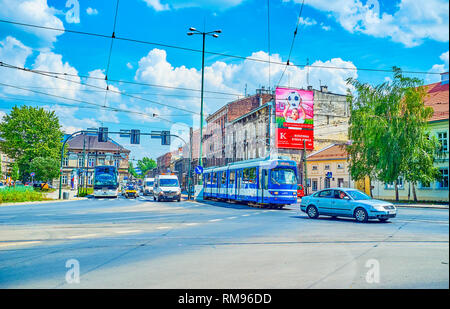 KRAKOW, POLAND - JUNE 21, 2018: The cars and public tram in Boleslawa Limanowskiego street of Podgorze district, on June 21 in Krakow. Stock Photo