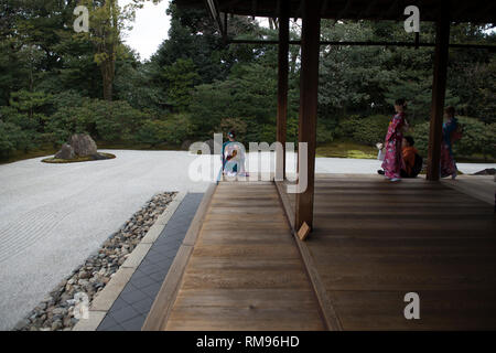 Geishas on Pavilion Verandah, Women dressed in traditional kimonos outside pavillion by Japanese rock garden, Karesansui in Japanese, Kennin-ji Stock Photo
