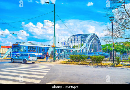 KRAKOW, POLAND - JUNE 21, 2018: The traffic in Krakowska street, the tram rides along Marshal Jozef Pilsudski bridge across the Vistula river, on June Stock Photo