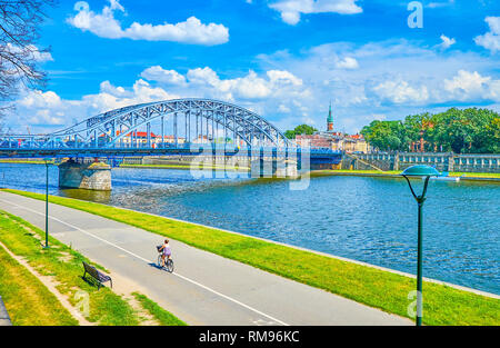 Pedestrian walkway of Kurlandzki Boulevard with a view on Marshal Jozef Pilsudski bridge across the Vistula river, Krakow, Poland Stock Photo