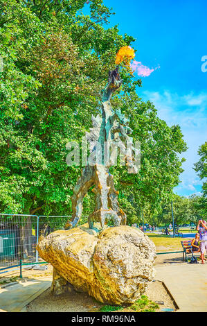 KRAKOW, POLAND - JUNE 21, 2018: The bronze monument to the breathing fire Wawel Dragon is a popular landmark of the city, located on the embankment of Stock Photo