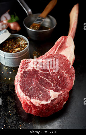 Rib-eye steak in a rustic plate on wooden table Stock Photo - Alamy