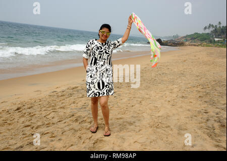 woman waving scarf, kollam beach, Trivandrum, Kerala, India, Asia, MR#802B Stock Photo
