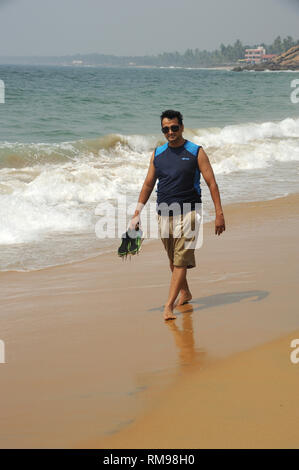 man walking kollam beach, Trivandrum, Kerala, India, Asia, MR#801B Stock Photo