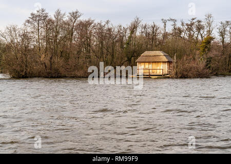 Near Wroxham, Norfolk, England, UK - April 07, 2018: A house on the shore of the Wroxham Broads Stock Photo