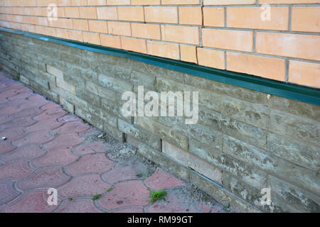 House foundation wall damage repair. Repair damaged foundation, foundation cracks. Stock Photo