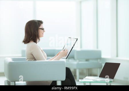 businesswoman checking financial documents in the workplace Stock Photo