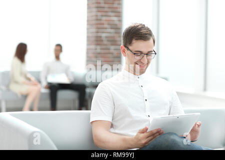 modern man uses a digital tablet for reading Stock Photo
