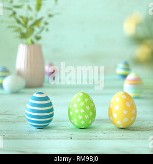Three colorful Easter eggs decorated with stripes, flowers and spots in blue, green and yellow on green wood background with copy space for your holid Stock Photo