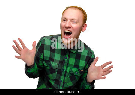 isolated portrait of red hair positive man show his hands. teenager did surprise. redhead guy laughs. reaction to surprise is overjoyed shock. emotion is joyful, joy, happiness. confident, fun boy. Stock Photo