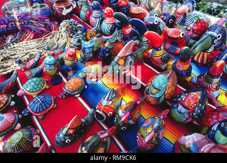 Colorful hand-painted ceramics of fish, turtles, birds, ducks and other figures are popular souvenirs for tourists visiting Guerrero State and its arts-and-crafts markets in Zihuatanejo, Mexico, North America. Stock Photo