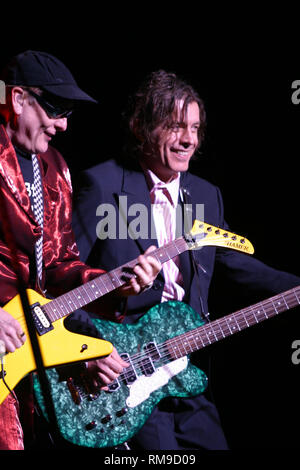 Cheap Trick band members Rick Nielson and Tom Peterson are shown performing 'live' in concert during  a concert appearance. Stock Photo