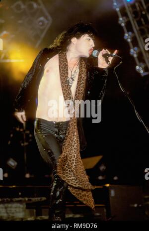 Cinderella singer and guitarist Tom Keifer is shown performing on stage during a 'live' concert appearance. Stock Photo