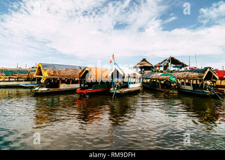 Colourful traditional wooden boats lined up in the port of Iquitos floating on the Amazon river in Peru, Latin America. Stock Photo