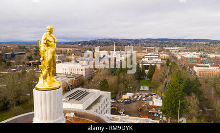 The state capital building adorned with the Oregon Pioneer with downtown Salem in the background Stock Photo