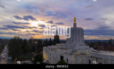 The state capital building adorned with the Oregon Pioneer with downtown Salem in the background Stock Photo