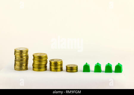 Mini houses and euro coins, Real estate investment, save money with stack coin, business growth investment and financial, renting home, mortgage conce Stock Photo