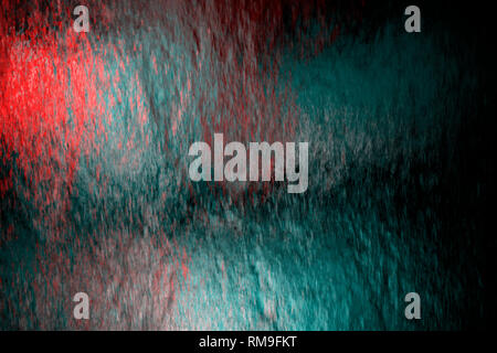 Water flow on glass with colored light show from behind Stock Photo