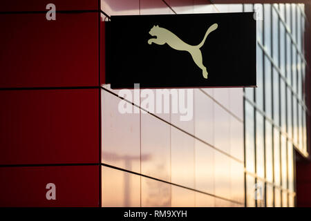 14 February 2019, Bavaria, Herzogenaurach: The logo of the sporting goods manufacturer Puma SE hangs on the outside facade of the company's headquarters. On 14 February, the sporting goods manufacturer will present its balance sheet for the year 2018. Photo: Daniel Karmann/dpa Stock Photo