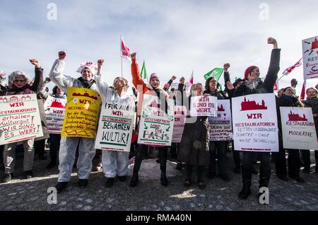 February 14, 2019 - Munich, Bavaria, Germany - To signify the failure of the second round of talks with employers, the German Verdi Ver.di labor union organized a 200+ strong flashmob action at the famed Schloss Nymphenburg in Munich to kick off a new strike wave.  The Union chose Castle Nymphenburg due to the pride and money Bavarian Ministerpresident Markus Soeder has invested into the castles of Bavaria, which in return have become major tourist attractions and income sources.  The union states that some of the money should be invested in the workers that that help keep these sites in opera Stock Photo