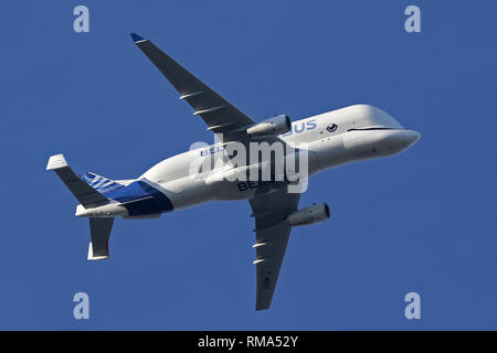 Hawarden Aerodrome/Broughton, UK. 14h February, 2019. Viewed from Waun-Y-Llyn country park, Hope Mountain, Wales, the Airbus BelugaXL lands in the UK for the first time as it visits Airbus Broughton as part of its test programme. The elevated location provides a different viewpoint with Ellesmere Port providing the backdrop and the many spectators vehicles visible on the surrounding roads Designed, built and to be operated by Airbus this successor to the Beluga will be used to move oversized aircraft components between Airbus sites. Credit: Paul Bunch / Alamy Live News. Stock Photo