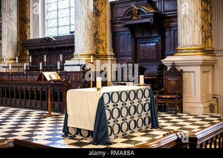 BIRMINGHAM, UK - March 2018 Bishop Seat is Between Two Pedestals. Altar Table Standing in Middle covered with White Blue Cloth. Intricate Art Carvings Stock Photo