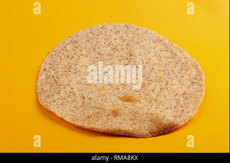 Toasted tortilla on yellow background angle view Stock Photo