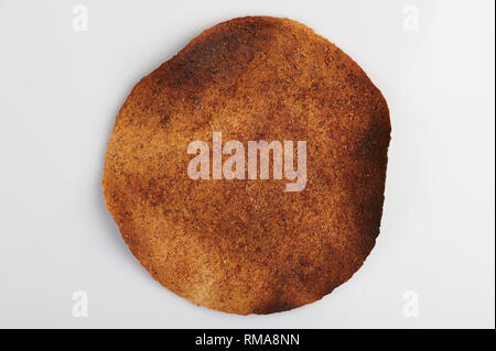 Brown burnt whole tortilla isolated on white background Stock Photo