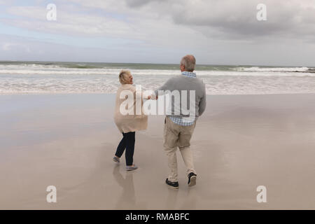 Senior couple dancing together on the beach Stock Photo