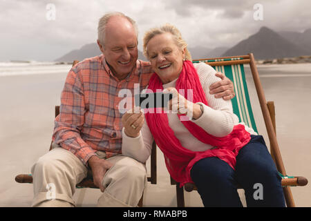 Senior couple using mobile phone Stock Photo