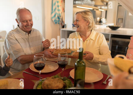 Senior couple interacting with each other on dining table Stock Photo