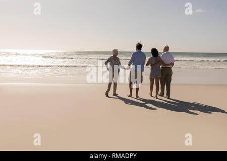Family walking on beach Stock Photo