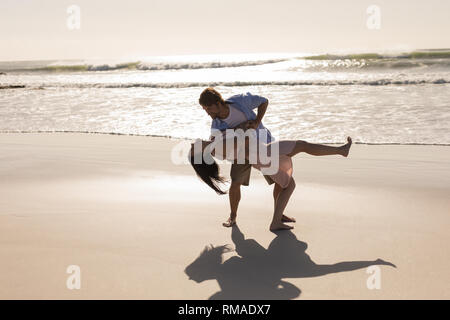 Romantic young couple dancing on beach Stock Photo