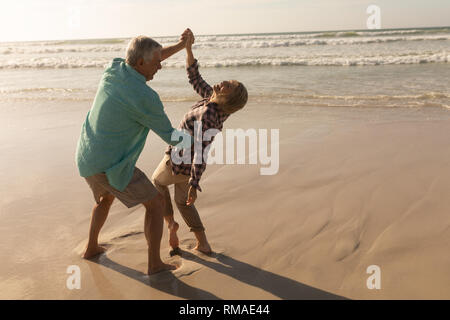 Senior couple dancing together on the beach Stock Photo