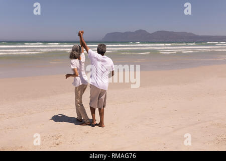 Senior couple dancing together on beach Stock Photo