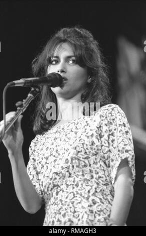Vocalist, guitarist and actress Susanna Hoffs, best known as a member of the all female pop band The Bangles, is shown on stage performing with her solo band. Stock Photo