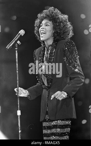 Singer Whitney Houston is shown performing on stage during a 'live' concert  appearance. Stock Photo