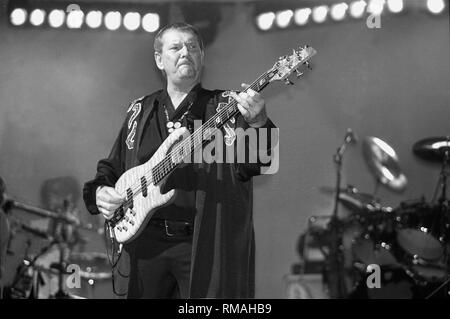 Bassist and singer Chris Squire of the progressive rock band Yes is shown performing on stage during a 'live' concert appearance. Stock Photo