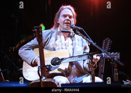 Canadian singer, songwriter, guitarist and film director Neil Young is shown performing on stage during a 'live' concert appearance. Stock Photo